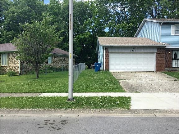 Other side of house with gate to the fenced back yard.