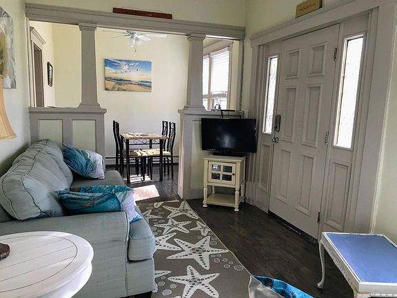 Front door opens to covered porch facing a park