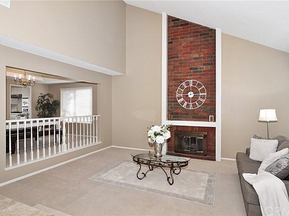 Beautiful living room with Cathedral vaulted ceiling & fireplace.