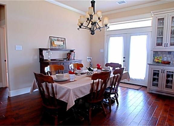 The dining room will accomodate any size table and chairs.  The gleaming hardwoods continue through this room and creates a very warm atmosphere.  It has elegant lighting and crown molding.