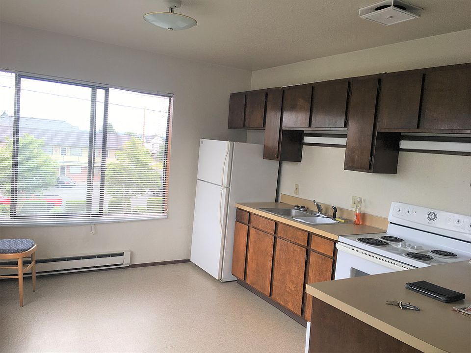 A corner kitchen layout, with tons of cabinets, full sized appliances.