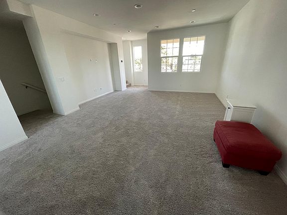 Living room with stairs coming from bottom 1st floor. Balcony on second floor.