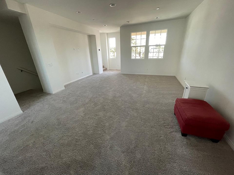 Living room with stairs coming from bottom 1st floor. Balcony on second floor.