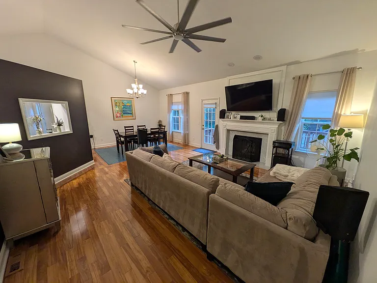 Living & Dining Area
Large open-concept living and dining area with vaulted ceilings, a large ceiling fan, room for a big TV and direct access to the back porch. Ideal for relaxing or entertaining.