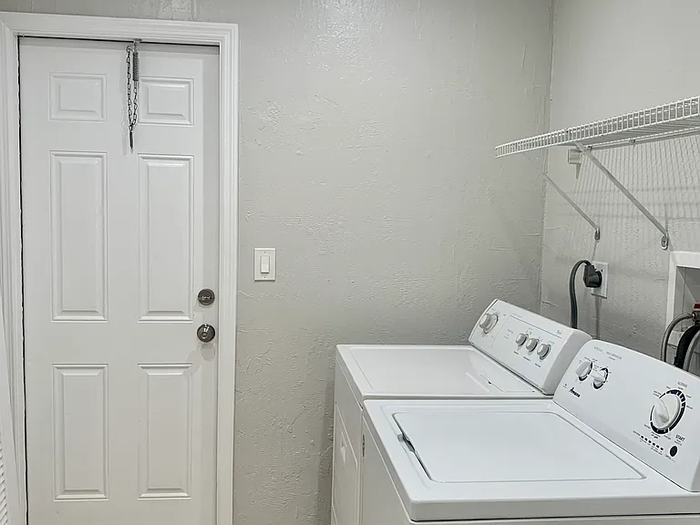 the private laundry room is located just off the kitchen with entrance to private garden and patio.