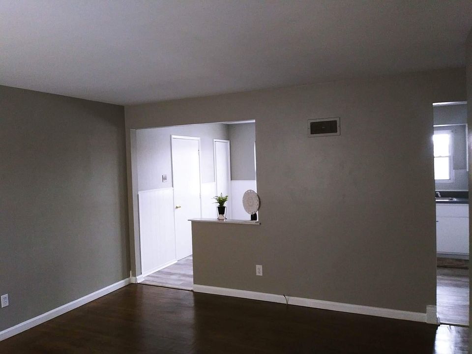 Large living room with easy access to the rest of the house and hardwood floors.