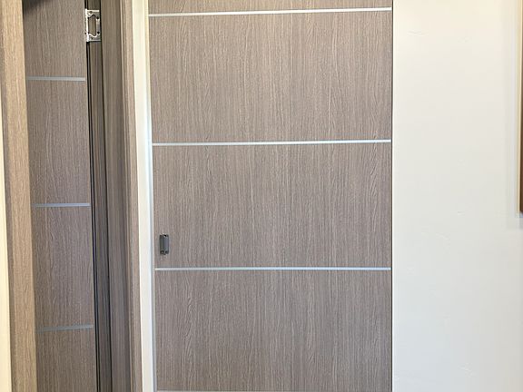 Downstairs entry with closed pivot door