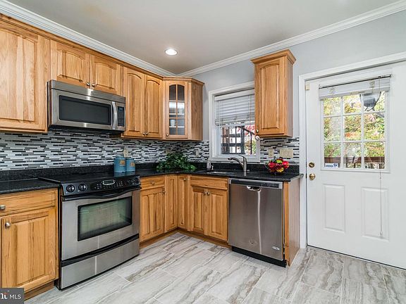Kitchen with door leading to rooftop access