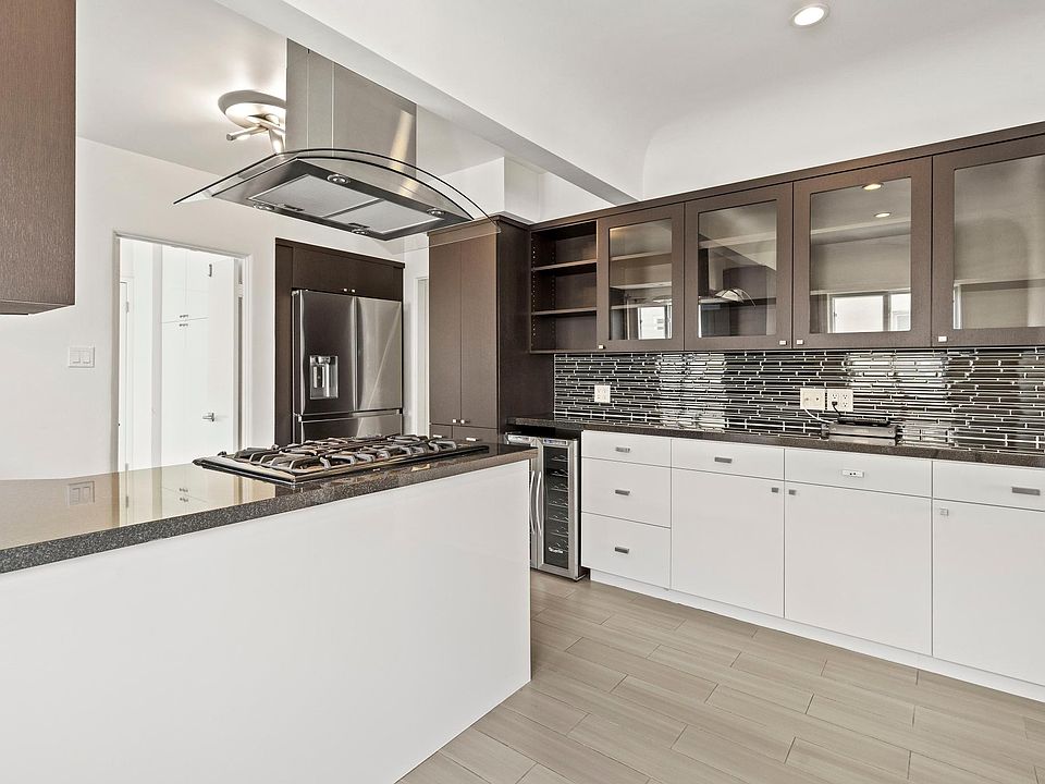 Kitchen from breakfast area view with high-end refrigerator plus wine fridge