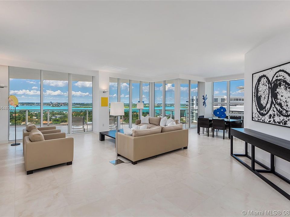 Grand living room and dining area with views of the Intracoastal Waterway, Haulover Sandbar and city.