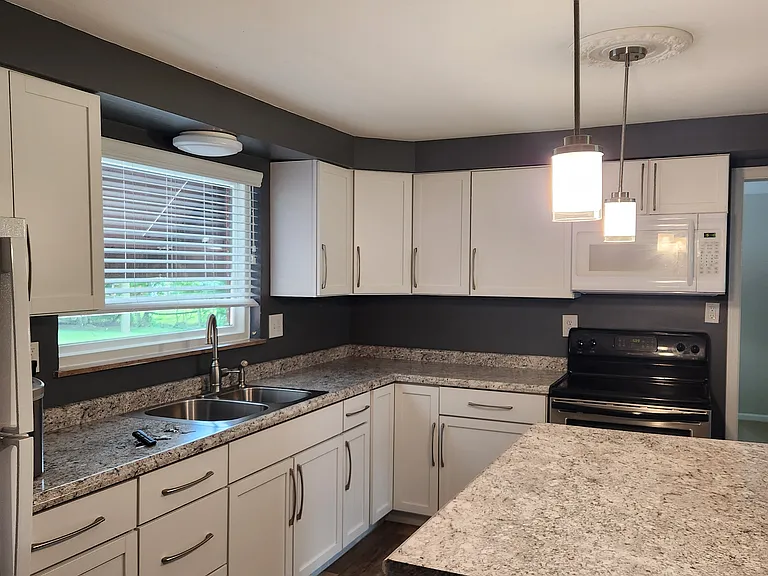 Remodeled kitchen with island and over island lights