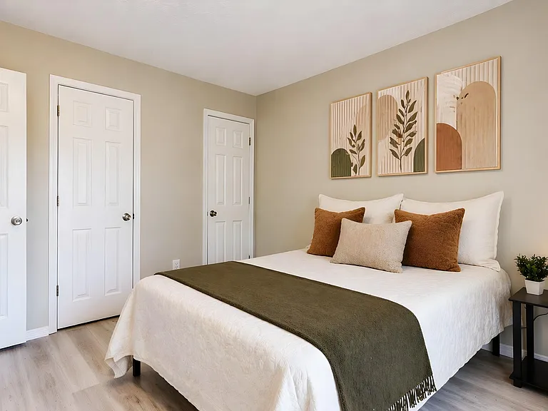 Well-appointed bedroom with a comfortable full/queen bed, bedside table and lamp, and convenient closet access.
