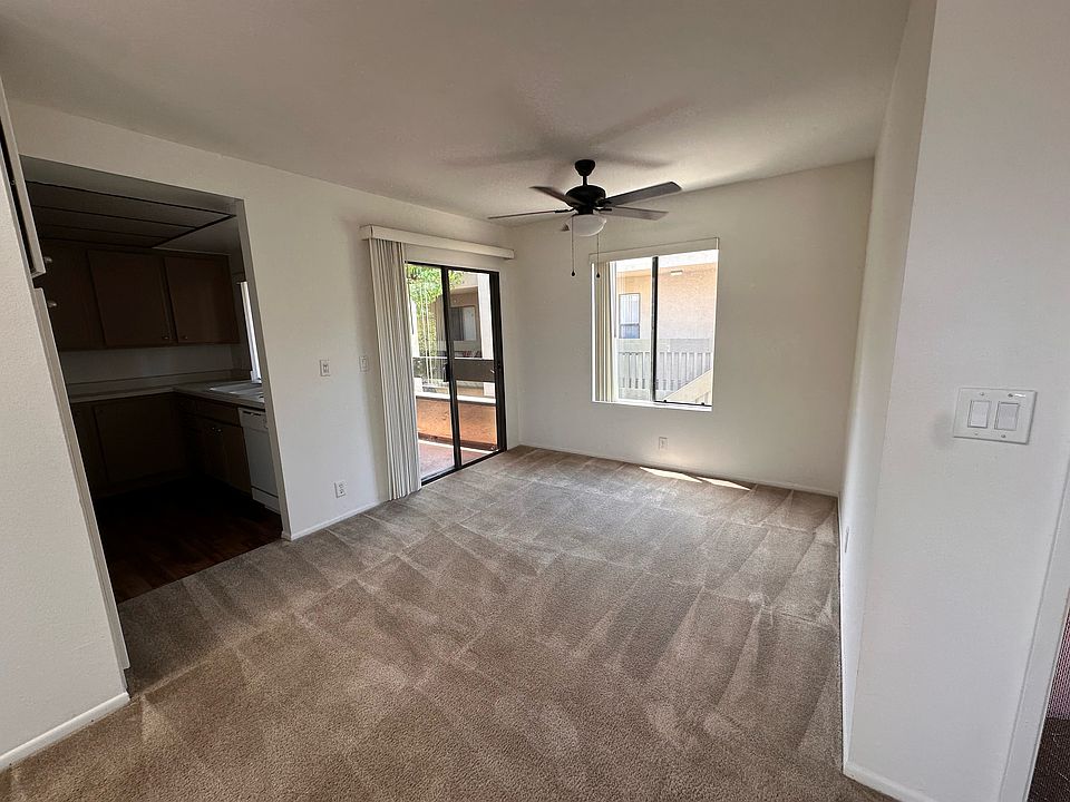 Dining area. Kitchen entrance to the left, balcony sliding door to the right.