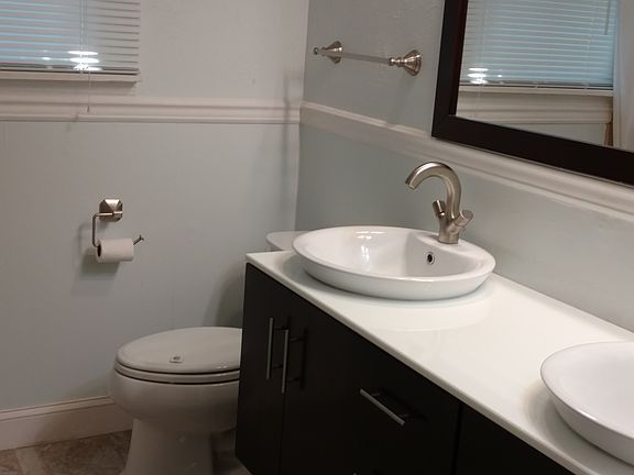 Newly renovated bathroom with tile floors and double vanity