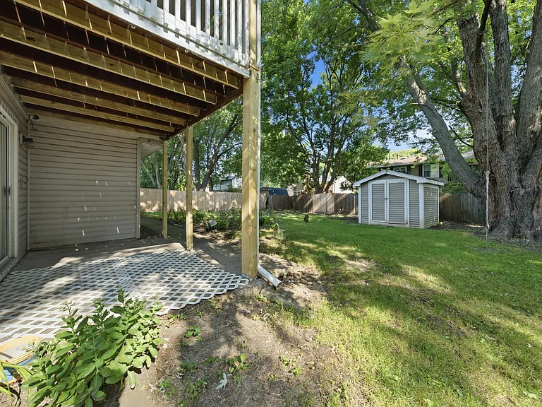 Large backyard with a storage shed