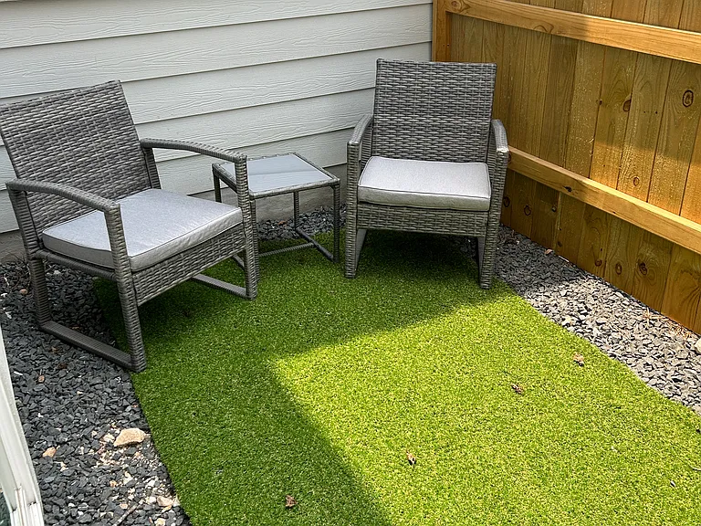 This home features a quaint enclosed patio space, perfect for enjoying a coffee in the morning.