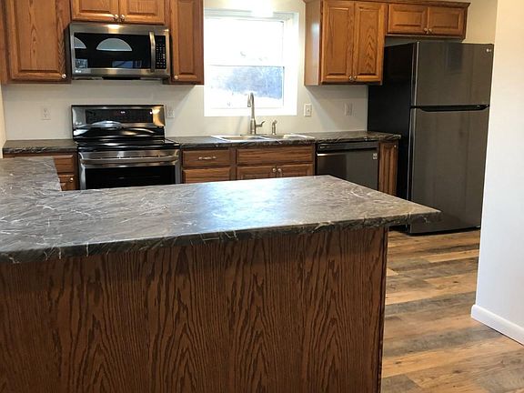Brand new kitchen with beautiful wood cabinets, all new black stainless steel appliances, large pantry and wood laminate flooring.