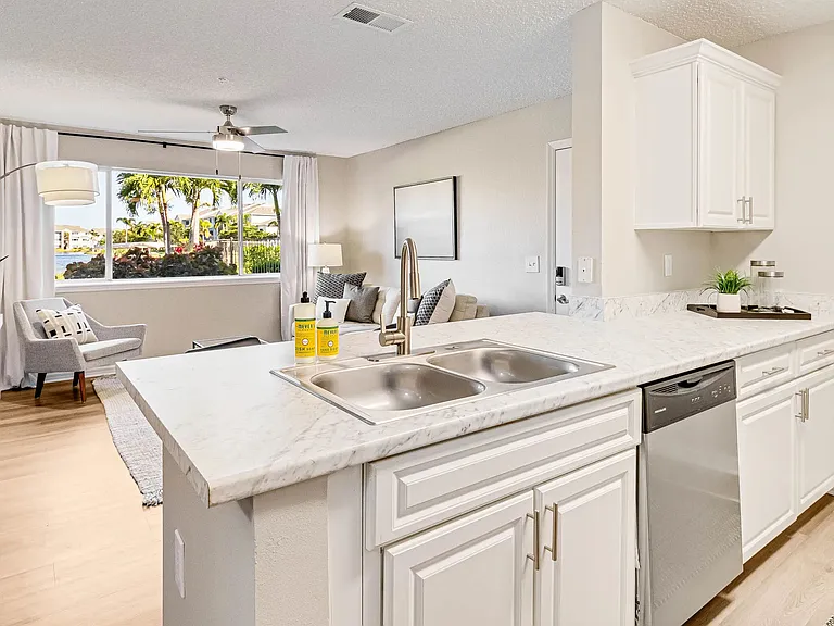 Open kitchens with wood-style flooring and a breakfast bar create an inviting space for culinary creativity.