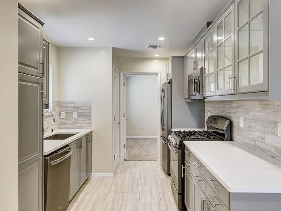 galley kitchen with view toward master