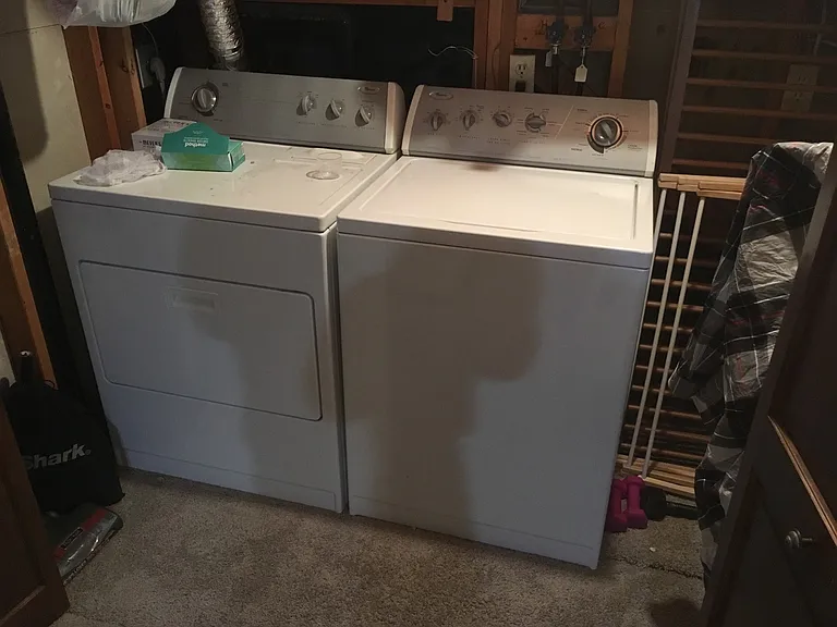 washer and dryer under stairs on lower level