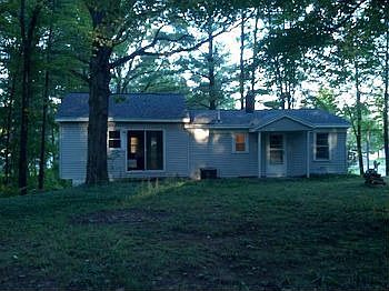 Back of home with possible patio area off of bedrooms.