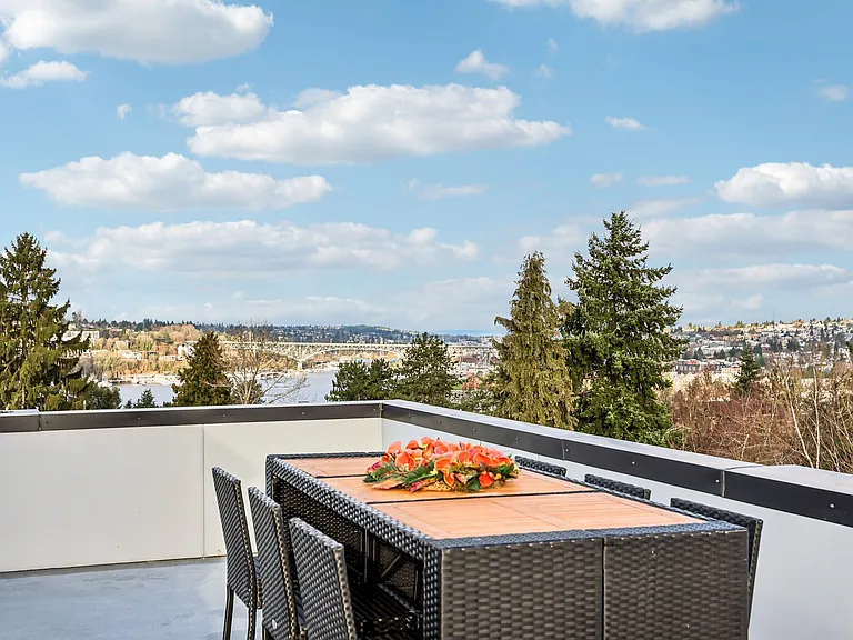 Huge roof-top deck with lake & mountain views includes a wet-bar, gas grill, and gas fire pit.