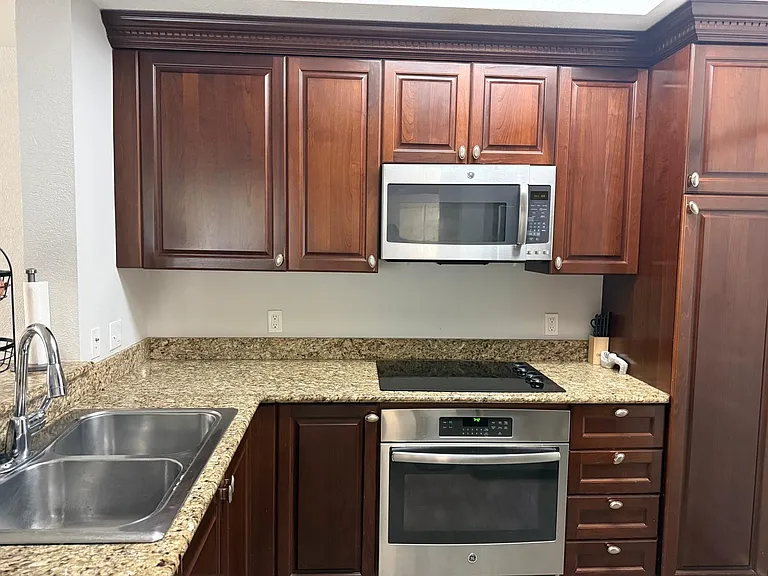 Chef's kitchen with GE Profile Stainless Steel Appliances and solid wood cabinets