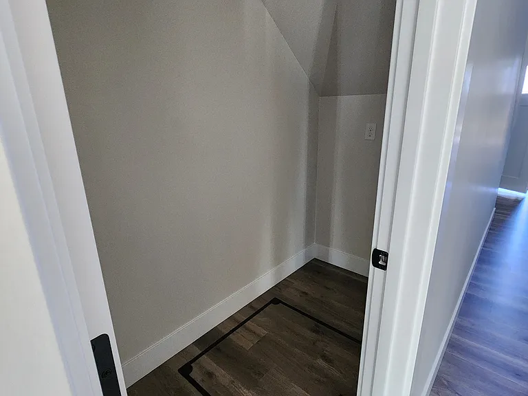 Storage space under the stairs with access to divided crawlspace.