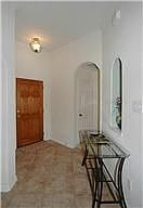 Walk in to high ceilings, archways and art niches.