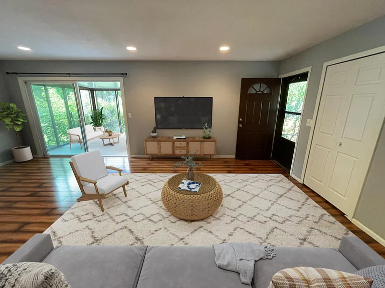 Living room with 3-season patio on the left, front entrance, and closet to the right. Great for hanging winter jackets.