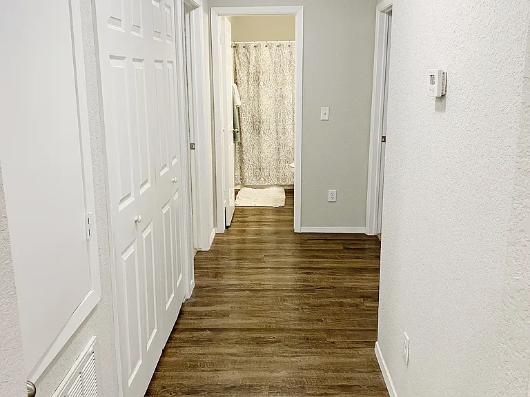 Hallway to the bedrooms. Washer/dryer are behind bi-fold doors on the left.