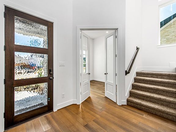 Glass and wood front door at foyer