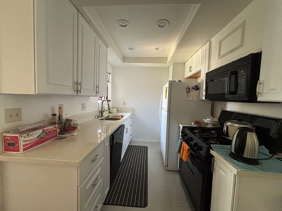 Galley kitchen with stove, oven, WD. (Fridge option to be discussed/determined)