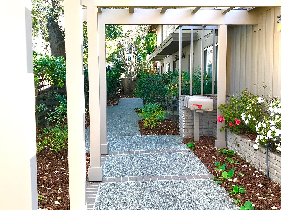 Entering walkway from the sidewalk. This walkway leads to all 3 front doors of the triplex.