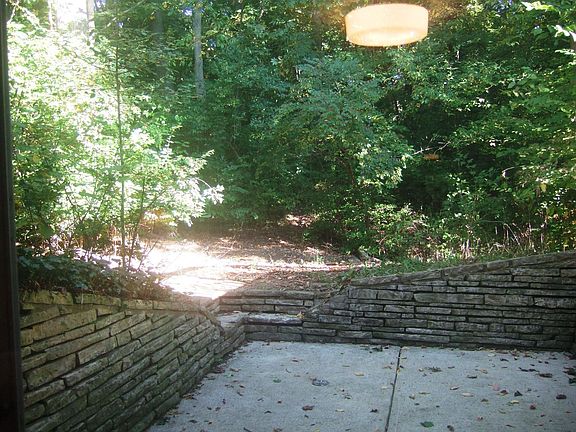 Lower level walkout to patio in woods
