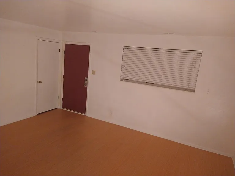 Living room vinyl flooring for easy cleaning, dead bolt door lock, and coat closet