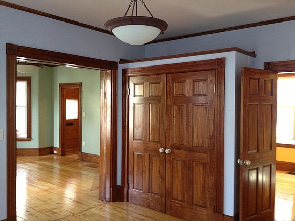 View of bedroom closet and living room from bedroom.