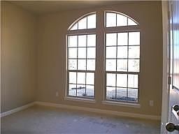 Front bedroom has arched windows.. and vaulted ceilings. Giving a spacious feel to this cozy home