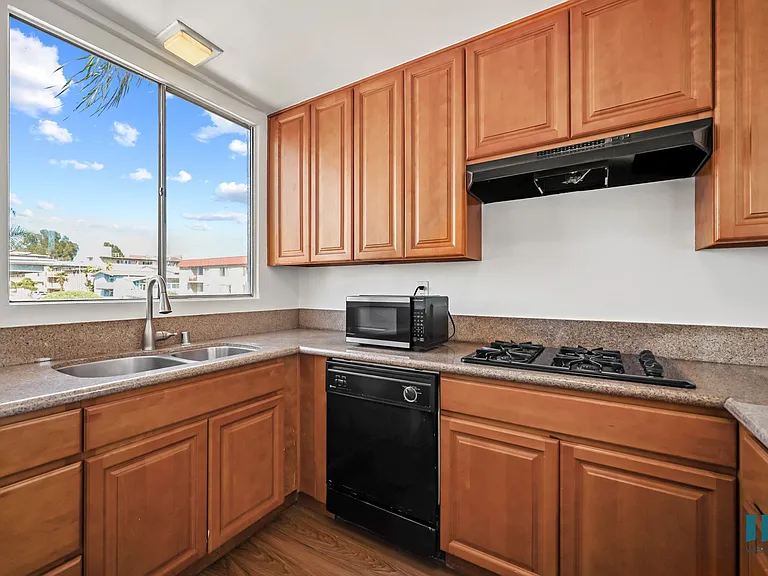 Kitchen with Gas Range, Dishwasher, microwave, and Large-Size Windows
