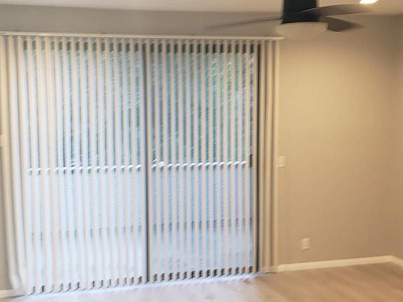 Living room with NEW FLOOR, recess lightings and NEW paint. It's very bright and patio is facing swimming pool.