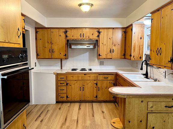 spacious kitchen with hand-built knotty pine cabinetry.