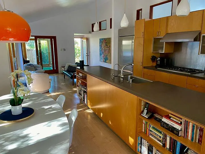 From the kitchen table looking towards the front seating area, entrance and office
