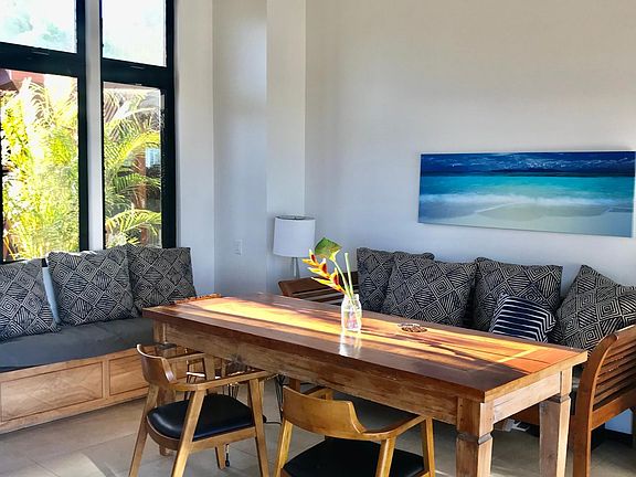 High ceilings and open floor plan. large teak table for dining and could be a work or creative area