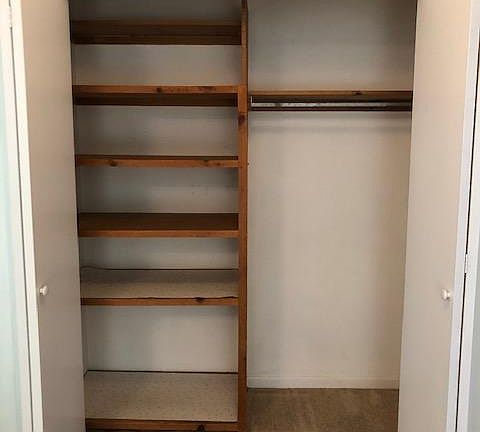 Linen closet outside bathroom open