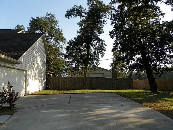 Side entry garage with view to fenced in back yard.   Double gate entry to back yard and extra 20 x 30 garage,