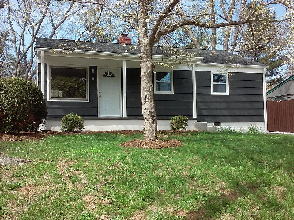 Front of home features a rocking chair porch