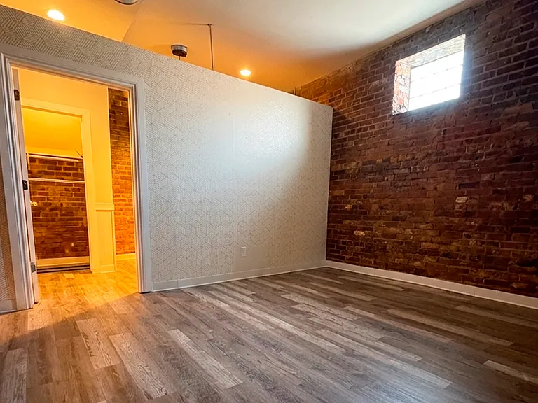 Authentic industrial loft aesthetics with warm, exposed brick wall accents.