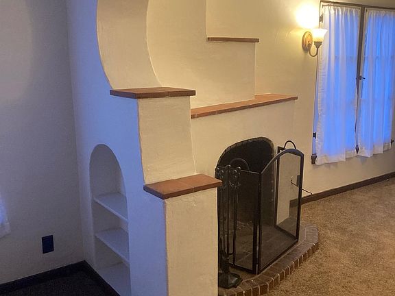 wood burning fireplace with built in book shelves