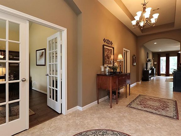 Welcome! Spacious entry with high tray ceiling and architecturally unique details such as archways and french doors. Study with hard wood flooring is to the left, formal dining to the right, two bedrooms and bath are to the left further down the hall