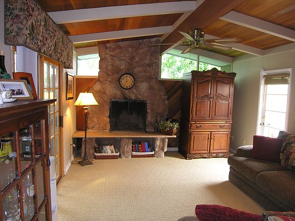 Family Room With Vaulted Ceiling And Rock Fire Place.
